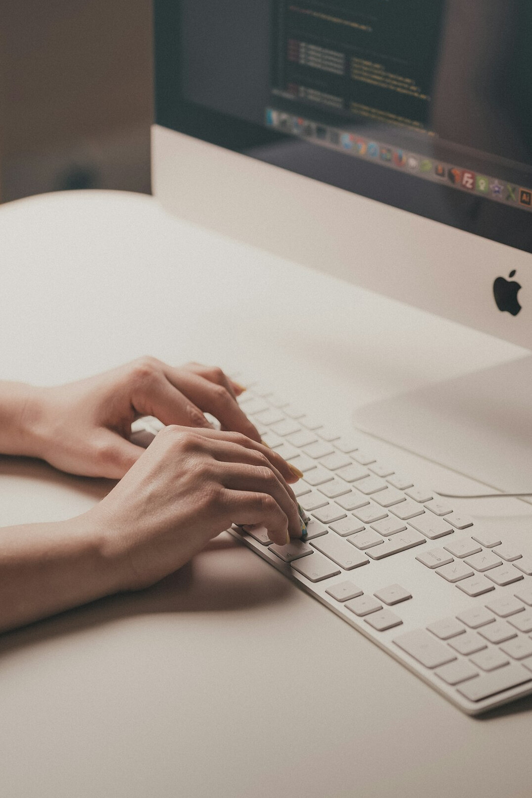 Hands typing on a laptop while evaluating data
