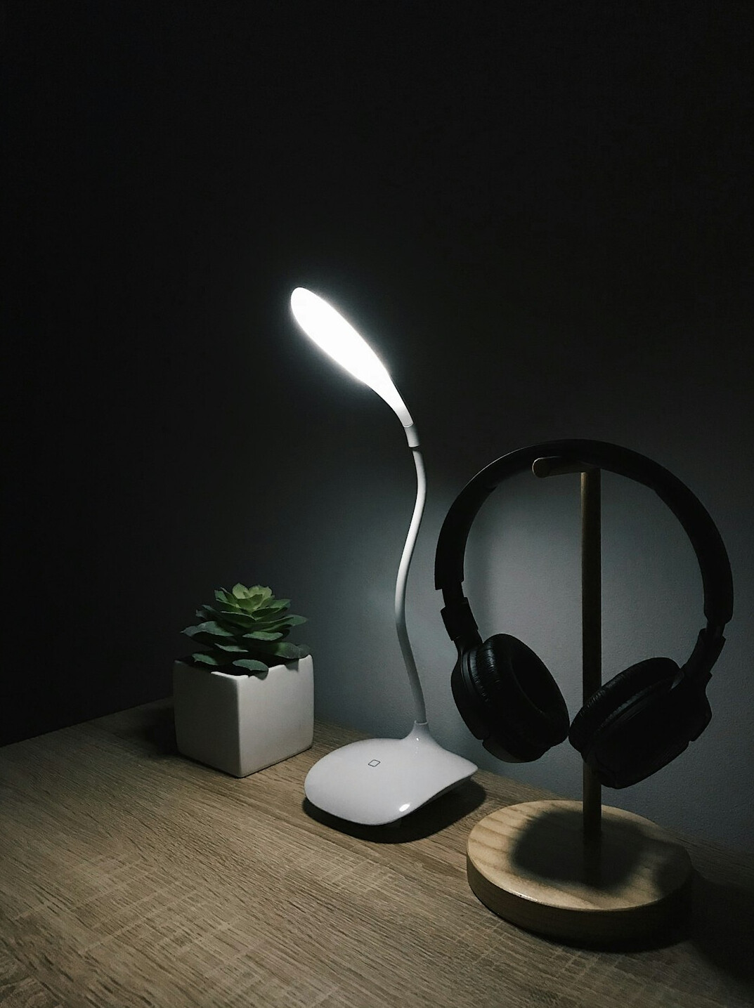 Laptop and smart devices on a dark desk during a product test